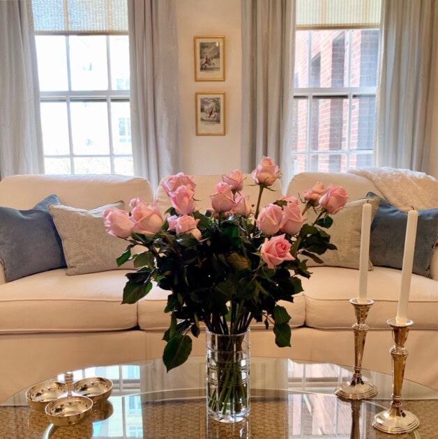 An antique vase with pink roses