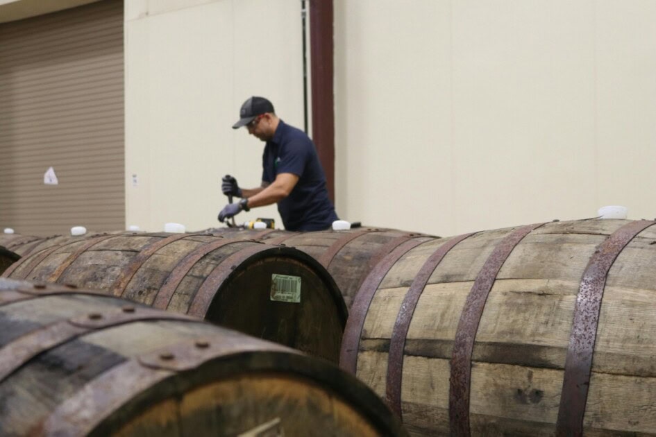 Man opening distillery barrels